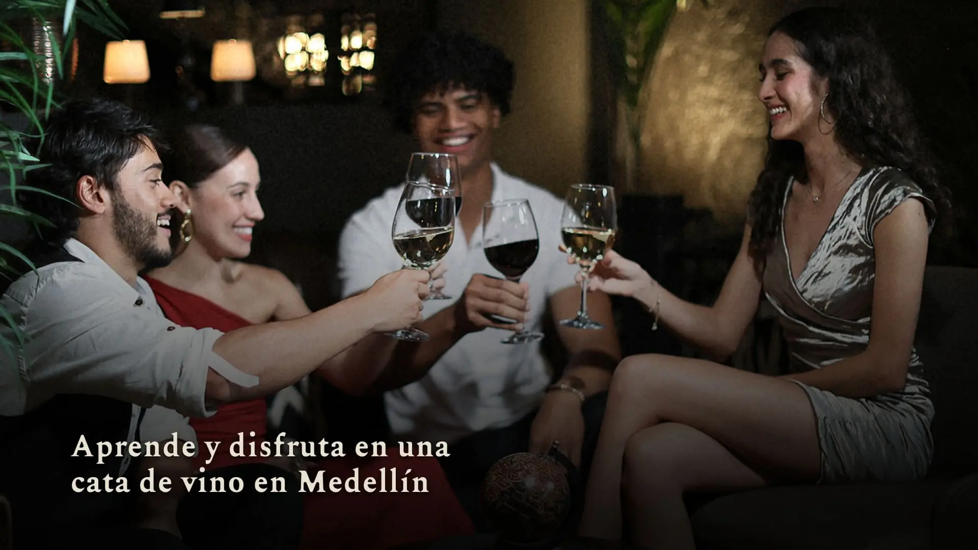 Cata de vino Group of four friends toasting with wine glasses in a dimly lit lounge, smiling and enjoying each other’s company.